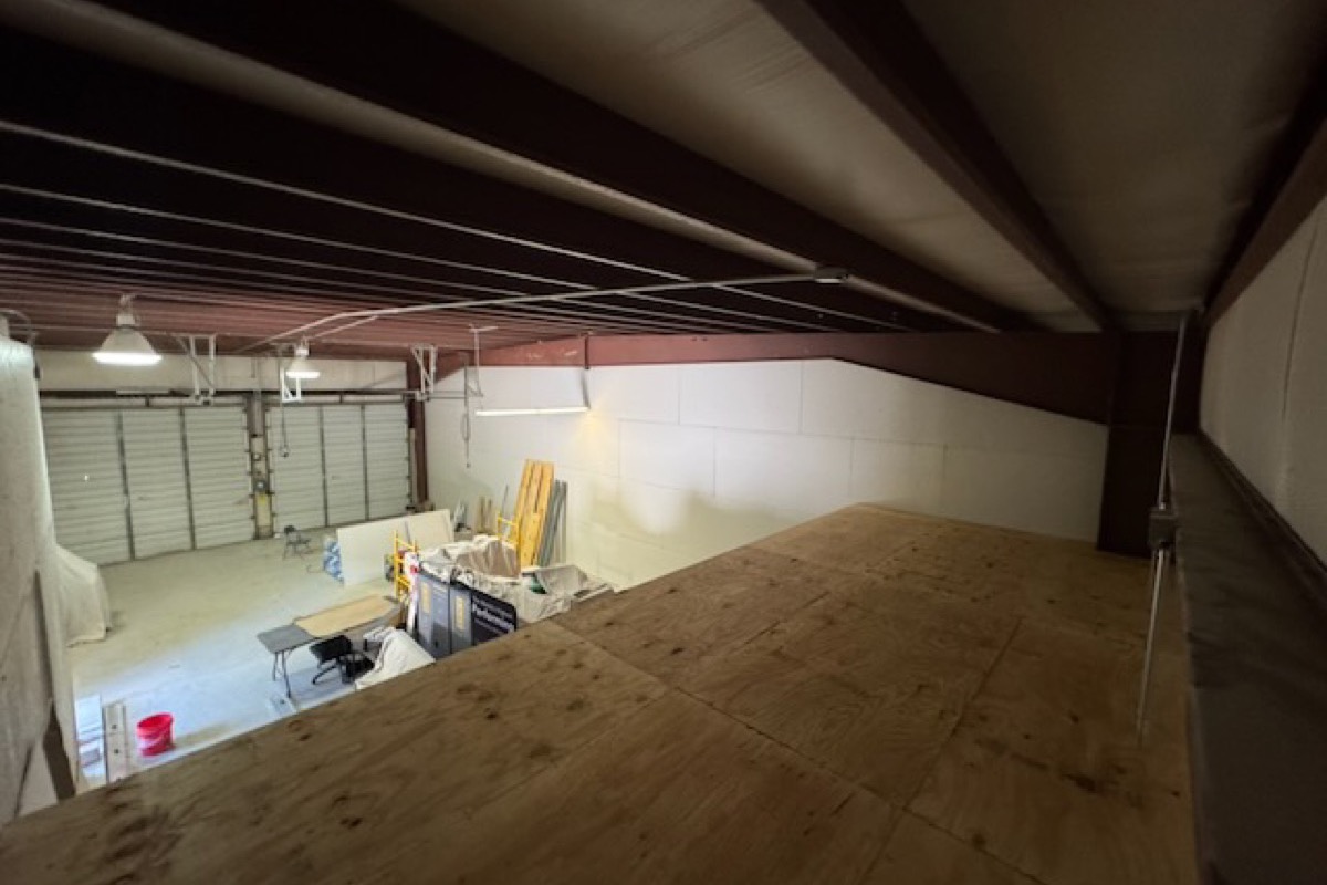 Interior of an open bay at 310 Innovation Drive, North Clarendon, Vermont, with the overhead door up.