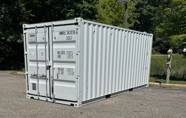 A 20 foot steel shipping container on the paved lot at 310 Innovation Drive