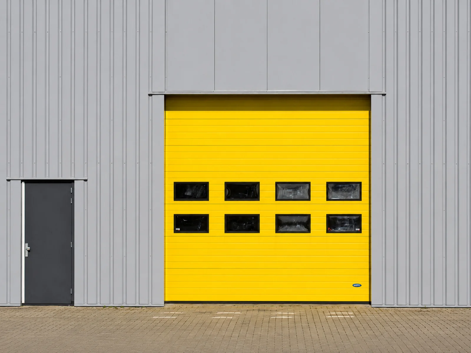 Industrial unit exterior with an overhead door and a separate personnel entrance